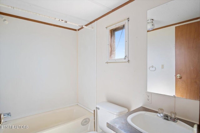 full bath featuring a sink, toilet, and tub / shower combination