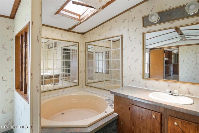 bathroom featuring wallpapered walls, vaulted ceiling, a garden tub, and vanity