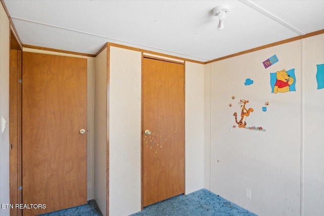 unfurnished bedroom featuring carpet, a closet, and crown molding