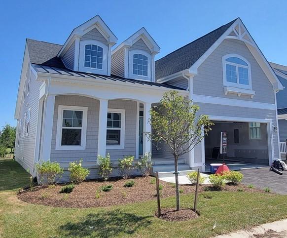 832 Westchester Cir, Hendersonville, TN 37075 - view of front of home featuring a garage, covered porch, a front lawn, a standing seam roof, and metal roof