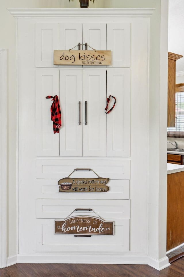 mudroom featuring dark wood-style flooring and baseboards