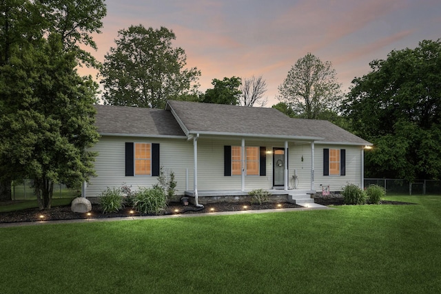 ranch-style home with a porch and roof with shingles