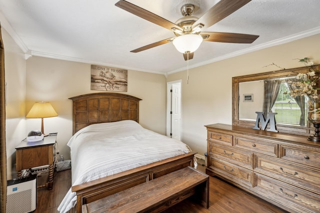 bedroom featuring dark wood finished floors, ornamental molding, and ceiling fan