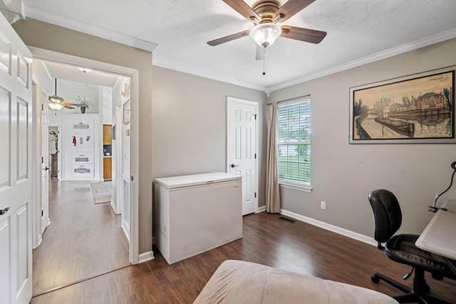 home office with ceiling fan, wood finished floors, ornamental molding, baseboards, and a textured ceiling