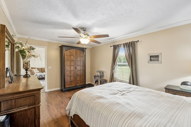 bedroom featuring ornamental molding, dark wood-style floors, a textured ceiling, a ceiling fan, and baseboards