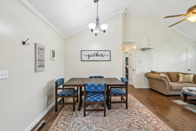 dining space featuring vaulted ceiling, dark wood-style floors, ceiling fan, ornamental molding, and baseboards