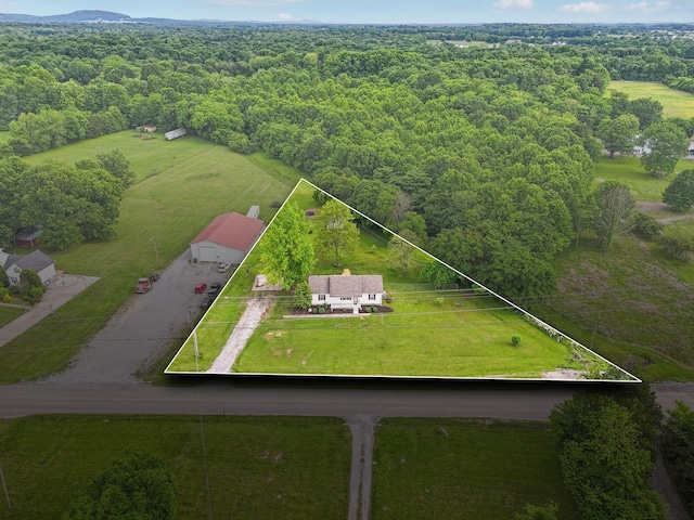 aerial view of property's location featuring property boundaries highlighted and a heavily wooded area