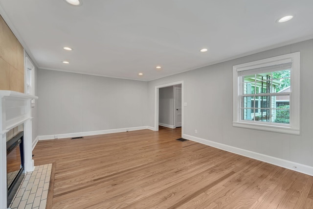 215 Wheeler Ave, Nashville, TN 37211 - unfurnished living room featuring light wood-style floors, a fireplace, recessed lighting, baseboards, and crown molding