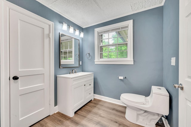 215 Wheeler Ave, Nashville, TN 37211 - bathroom with crown molding, a textured ceiling, toilet, wood finished floors, and vanity