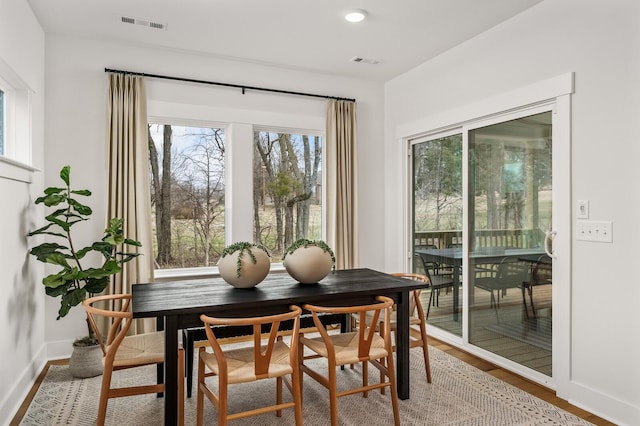 dining space with wood finished floors and baseboards