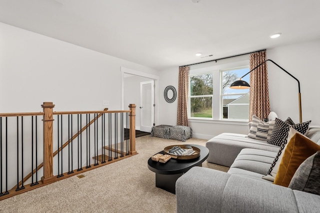 carpeted living room with recessed lighting and baseboards