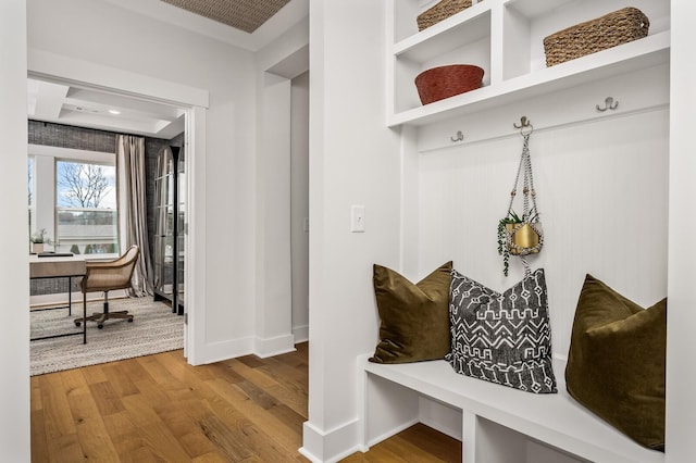 mudroom featuring wood finished floors and baseboards