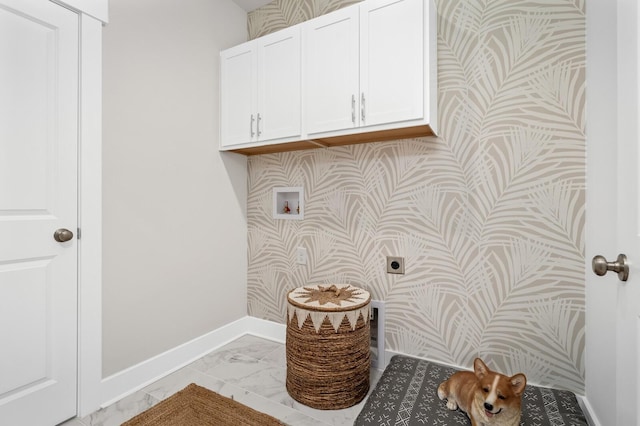 washroom featuring cabinet space, hookup for an electric dryer, light marble finish floors, baseboards, and hookup for a washing machine