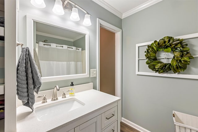 bathroom with ornamental molding, vanity, and curtained shower