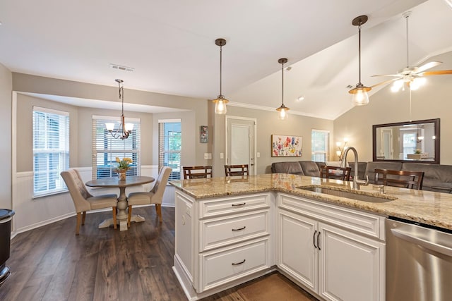kitchen with a sink, stainless steel dishwasher, light stone counters, white cabinetry, and lofted ceiling