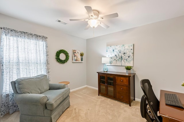 sitting room featuring ceiling fan, baseboards, an office area, and light colored carpet