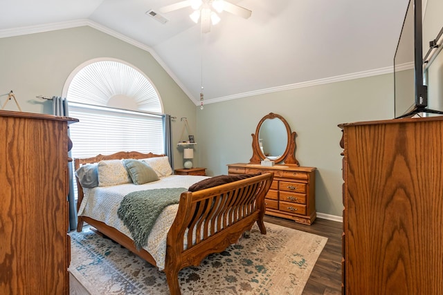 bedroom featuring lofted ceiling, wood finished floors, a ceiling fan, crown molding, and baseboards
