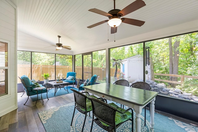 sunroom with a ceiling fan, outdoor lounge area, vaulted ceiling, and outdoor dining space