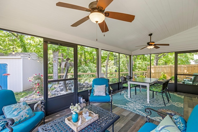 sunroom featuring outdoor dining area, a ceiling fan, lofted ceiling, and an outdoor living space