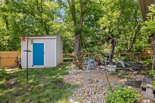fenced backyard with a storage shed and an outdoor structure