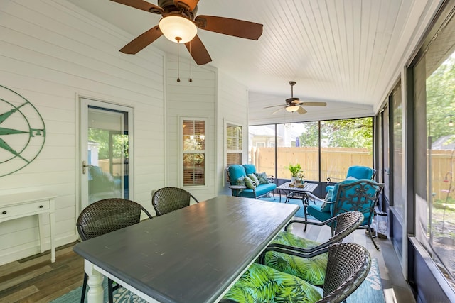 sunroom featuring vaulted ceiling, a ceiling fan, and plenty of natural light