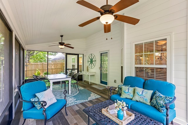 sunroom / solarium featuring lofted ceiling, a ceiling fan, an outdoor hangout area, and outdoor dining area