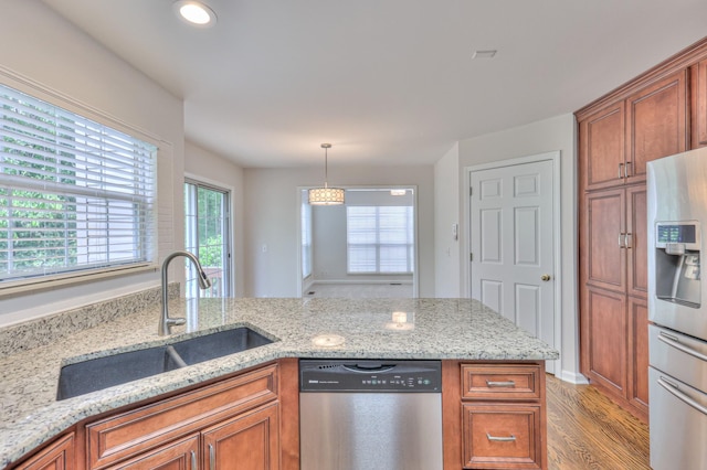 408 Parish Pl, Franklin, TN 37067 - kitchen featuring appliances with stainless steel finishes, a sink, light wood-type flooring, brown cabinets, and recessed lighting