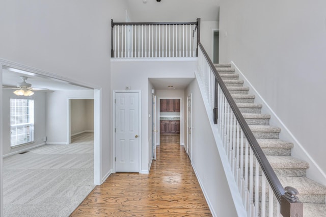 408 Parish Pl, Franklin, TN 37067 - staircase featuring baseboards, a high ceiling, wood finished floors, and a ceiling fan