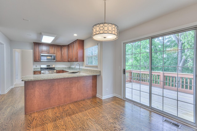 408 Parish Pl, Franklin, TN 37067 - kitchen with stainless steel appliances, a sink, wood finished floors, baseboards, and light stone countertops