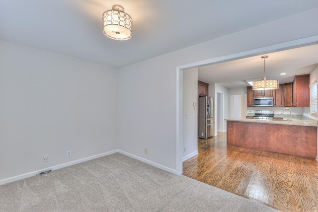 408 Parish Pl, Franklin, TN 37067 - kitchen with stainless steel appliances, baseboards, light countertops, and open floor plan