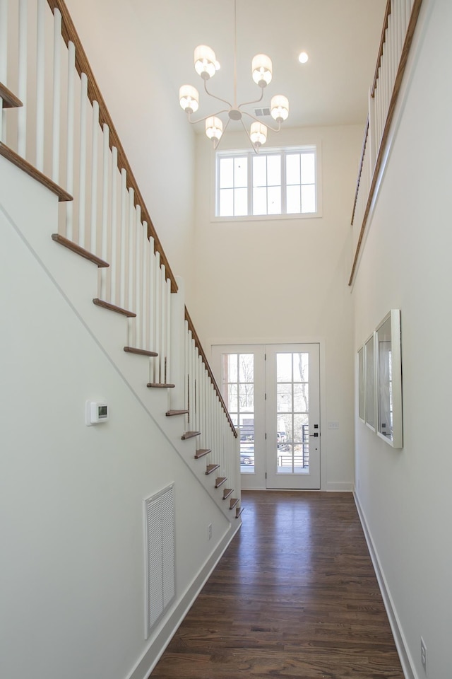 431B Basswood Ave, Nashville, TN 37209 - foyer entrance with a chandelier, a high ceiling, stairs, dark wood-style flooring, and baseboards