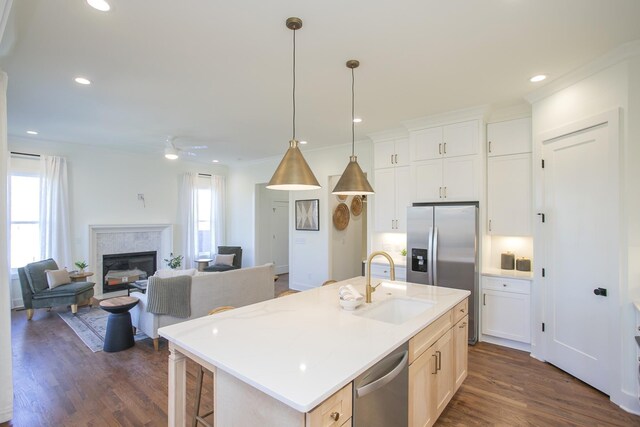 431B Basswood Ave, Nashville, TN 37209 - kitchen featuring a sink, appliances with stainless steel finishes, dark wood-type flooring, a glass covered fireplace, and pendant lighting