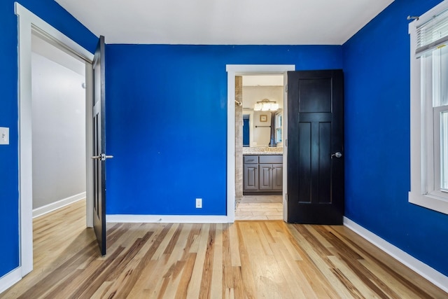 4408 Alpine Way, Murfreesboro, TN 37129 - unfurnished bedroom featuring light wood-style flooring, baseboards, and multiple windows