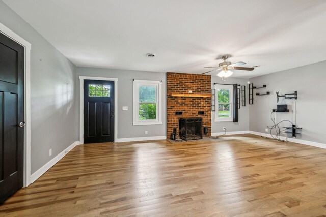 4408 Alpine Way, Murfreesboro, TN 37129 - unfurnished living room with ceiling fan, light wood-type flooring, baseboards, and a brick fireplace