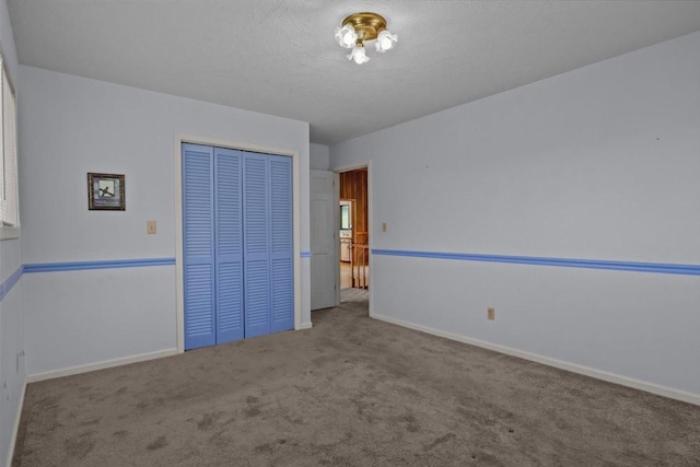 4410 Trace Creek Rd, Mc Ewen, TN 37101 - unfurnished bedroom featuring carpet flooring, a closet, baseboards, and a textured ceiling