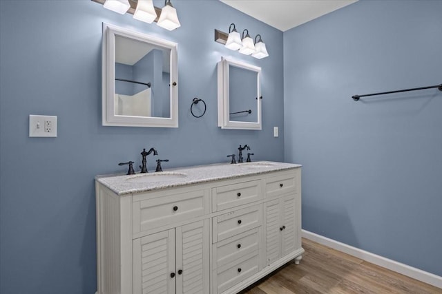 4410 Trace Creek Rd, Mc Ewen, TN 37101 - full bathroom featuring wood finished floors, baseboards, and double vanity