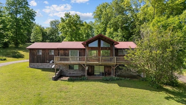 4410 Trace Creek Rd, Mc Ewen, TN 37101 - rear view of property featuring a lawn, metal roof, and a deck
