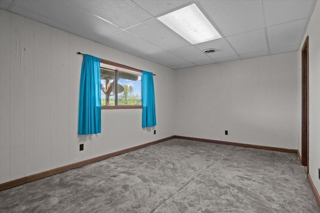 4410 Trace Creek Rd, Mc Ewen, TN 37101 - empty room featuring a drop ceiling, baseboards, and wooden walls