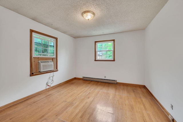 1006 Hillcrest Cir, Pleasant View, TN 37146 - empty room with baseboard heating, light wood-style flooring, a textured ceiling, baseboards, and cooling unit