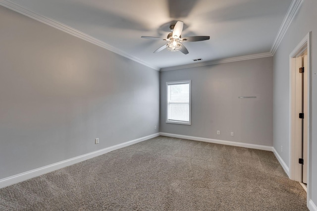 carpeted empty room featuring ornamental molding, ceiling fan, and baseboards