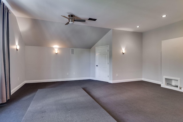 empty room with ceiling fan, vaulted ceiling, dark colored carpet, baseboards, and recessed lighting