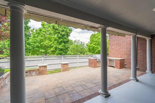 view of patio / terrace featuring fence and an outdoor kitchen