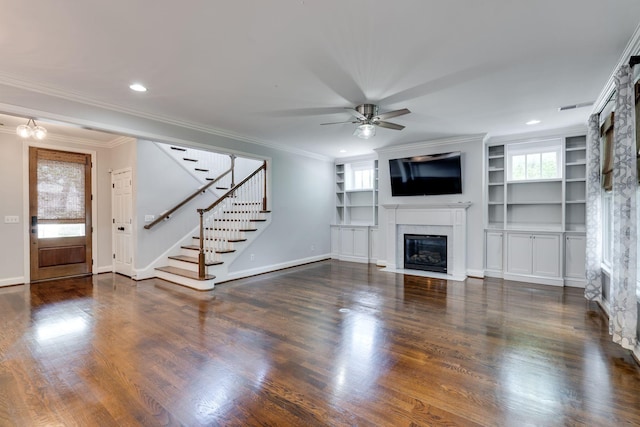 unfurnished living room with a fireplace with flush hearth, stairs, ceiling fan, baseboards, and ornamental molding