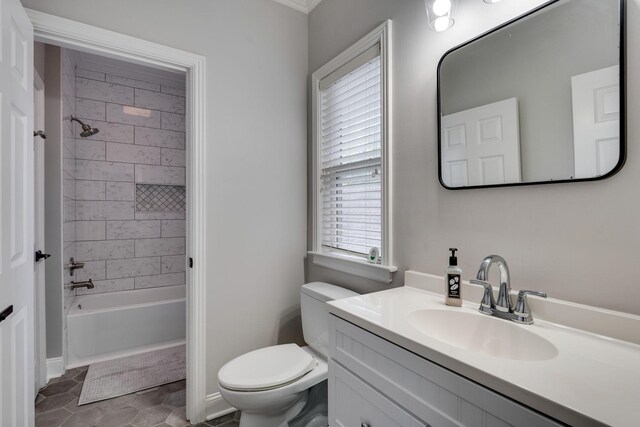 bathroom with toilet, vanity, shower / washtub combination, baseboards, and tile patterned floors