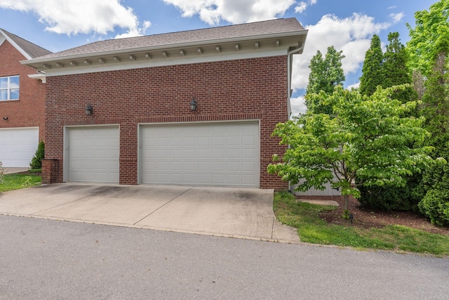 garage with concrete driveway
