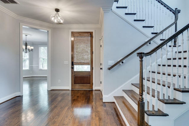 foyer featuring a chandelier, dark wood finished floors, stairway, and crown molding