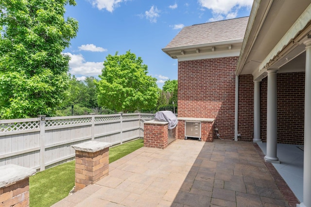 view of patio featuring fence, grilling area, and area for grilling