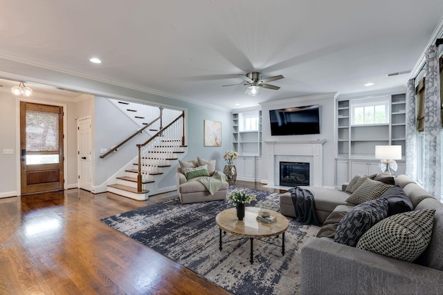 458 Wiregrass Ln, Franklin, TN 37064 - living room featuring dark wood-type flooring, stairway, a fireplace with flush hearth, crown molding, and ceiling fan