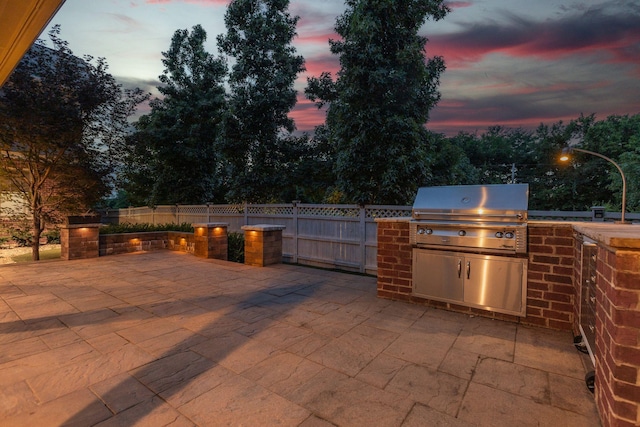 458 Wiregrass Ln, Franklin, TN 37064 - patio terrace at dusk featuring a patio and exterior kitchen