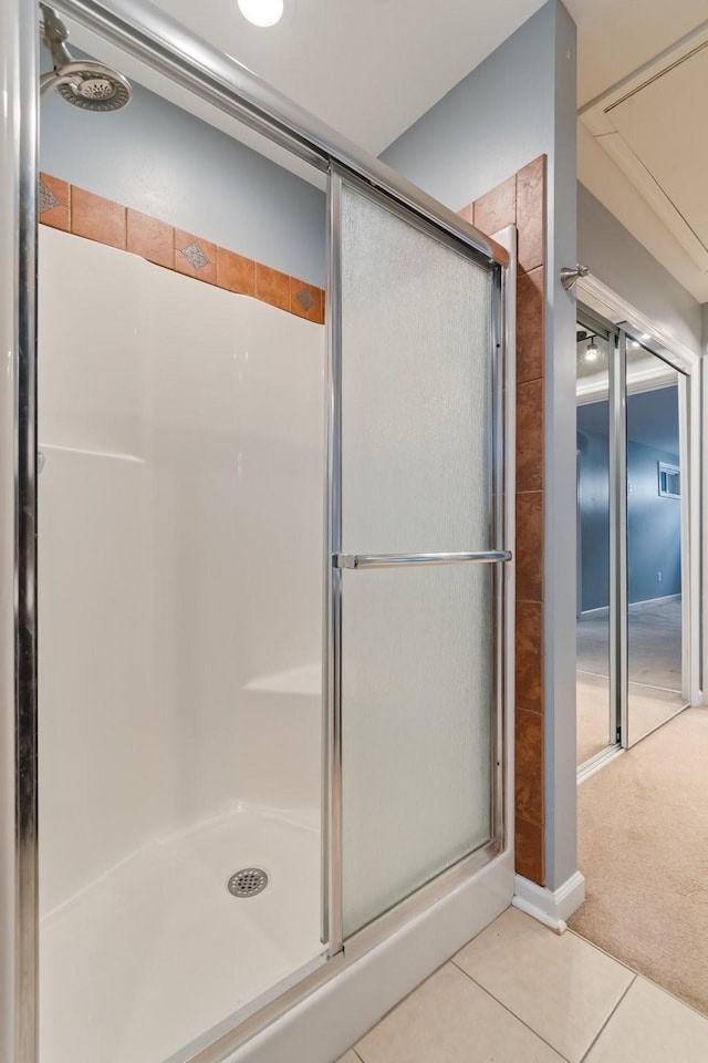 bathroom featuring a shower stall and tile patterned flooring